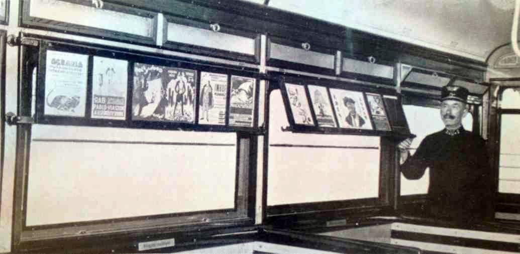 Tram posters being displayed in their cabinet on a tram